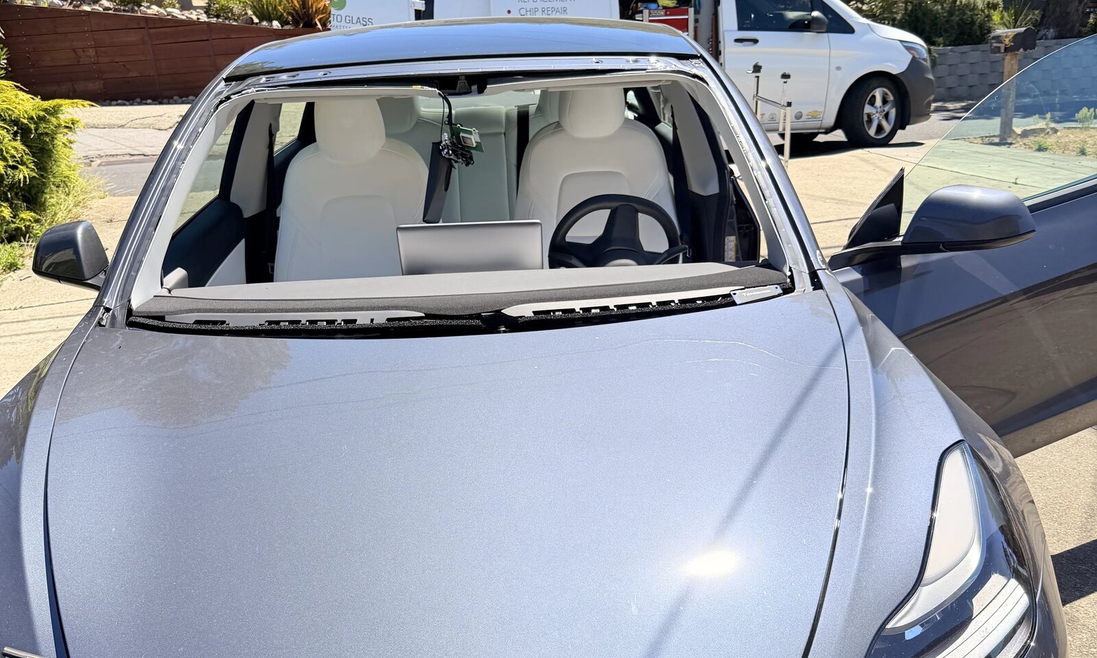 Mobile windshield replacement in progress on a Tesla Model 3 in Fremont